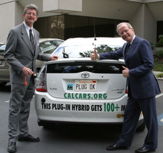 Felix and Set America Free's Bud McFarlane in front of Felix's PHEV